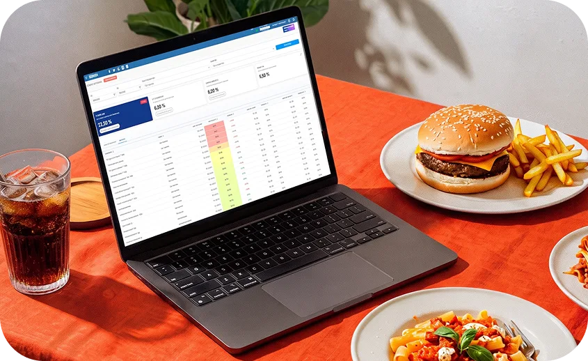 Notebook com relatório de CMV do sistema Saipos em mesa de restaurante